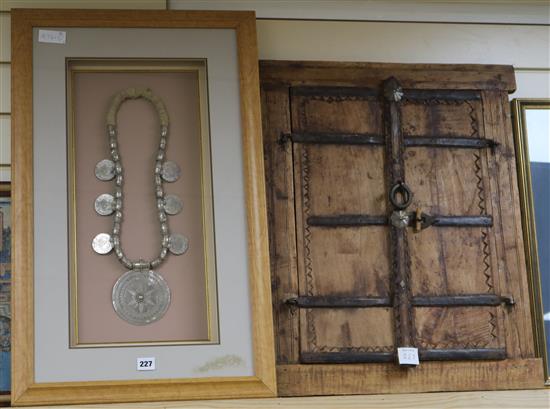 A framed wedding coun necklace and Indian shutters